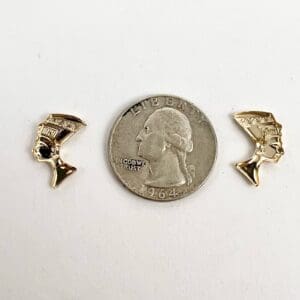 Gold earrings and a quarter coin.