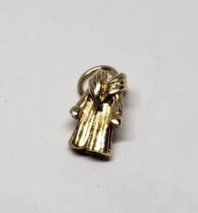Gold robe-shaped pendant on white background.