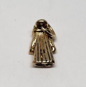 Gold robe-shaped pendant on white background.