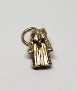 Gold robe-shaped pendant on white background.