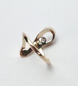 Gold ring with a single diamond accent.