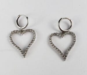 Heart-shaped silver earrings with rhinestones.