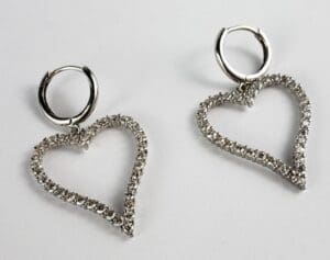 Heart-shaped diamond earrings on white background.