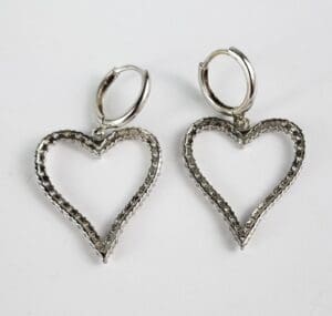 Silver heart-shaped hoop earrings on display.