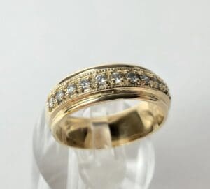 Gold ring with diamond accents on display.