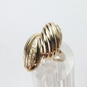 Gold ring with ribbed design and diamonds.
