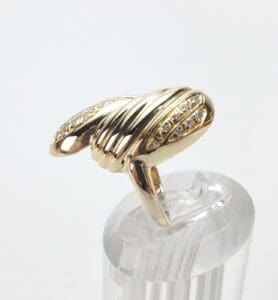 Gold ring with diamond accents on display.