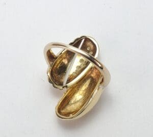 Gold ring with an abstract design.