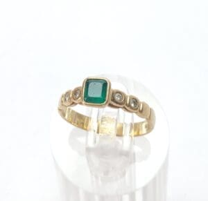 Gold ring with emerald and diamonds.
