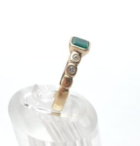 Gold ring with emerald and diamonds.