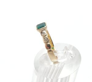 Gold ring with green and clear stones.
