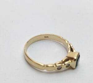 Gold ring with gemstone and small diamonds.