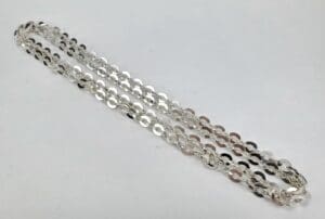 Silver chain necklace on white background.
