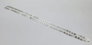 Silver chain necklace on white background.