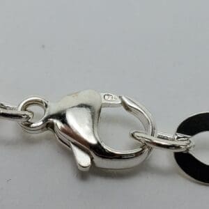 Silver lobster clasp with stamped "925" mark.
