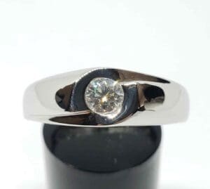 Silver ring with a central diamond.