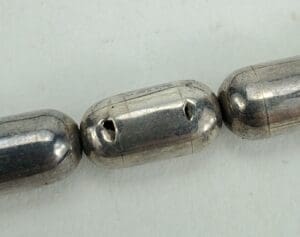 Silver metal oval beads close-up.