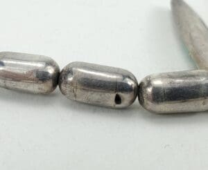 Silver metal beads on a string.