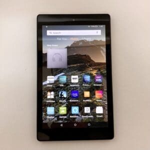 Tablet displaying apps with mountain wallpaper.