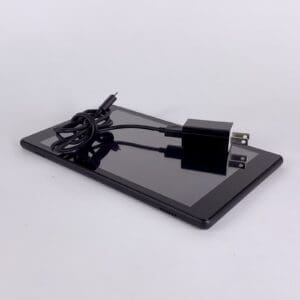 Tablet with charger on white background.