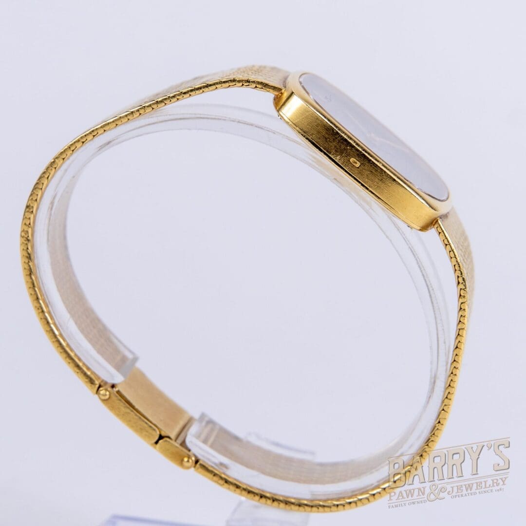 Gold wristwatch with a sleek design.