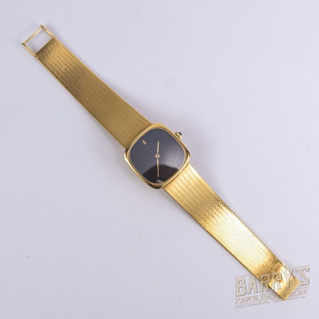 Gold wristwatch with black square face.