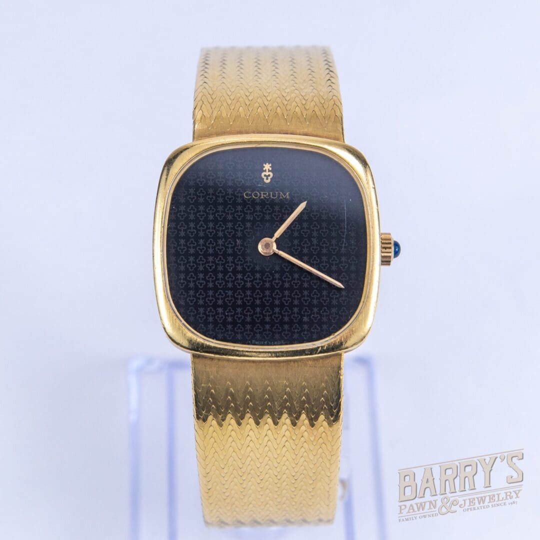 Gold wristwatch with black square dial.