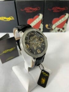 Black wristwatch with ornate face design.