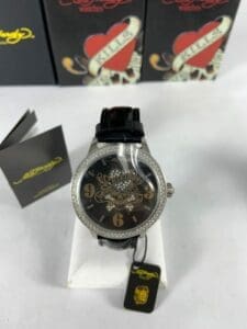 Black watch with tattoo-themed design.