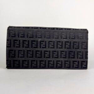 Black Fendi clutch with logo pattern.
