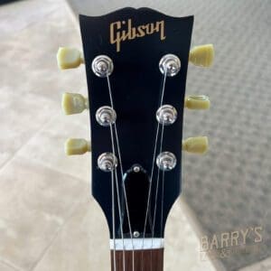 Guitar headstock with Gibson logo, six tuners.