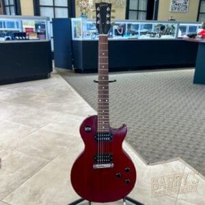 Red electric guitar in a store display.
