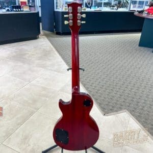 Red electric guitar displayed in store.