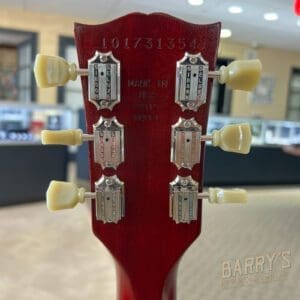 Back of guitar headstock with tuners visible.