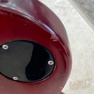 Red object with a black circular panel.