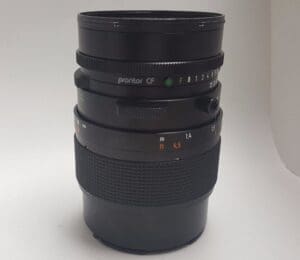 Camera lens with focus and aperture rings.