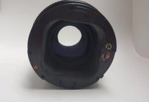 Circular camera lens on plain background.