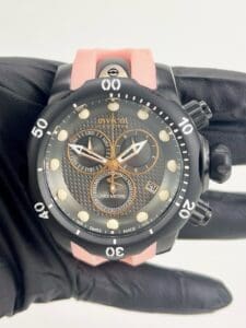 Black and pink diving watch with dials.