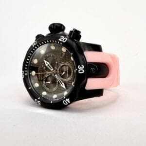 Black watch with pink strap on display.