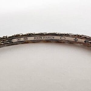 Silver bracelet engraved with "John Hardy.