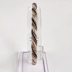 Silver and black twisted bangle bracelet.
