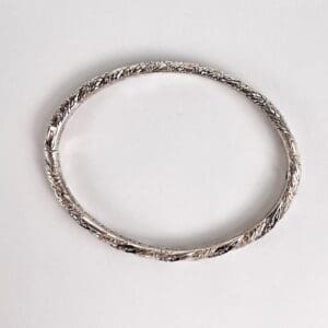 Silver bracelet with intricate braided design.