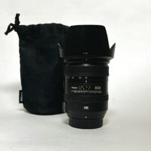 Nikon camera lens with black pouch.