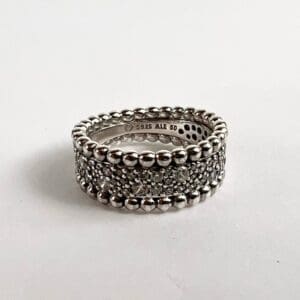 Silver ring with intricate bead detailing.