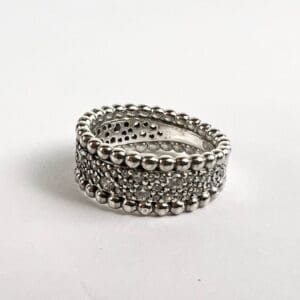 Silver beaded ring with intricate details.