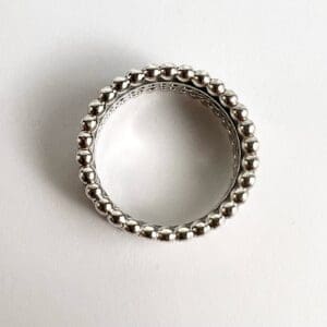 Silver ring with beaded edge design.