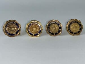 Four Plymouth Cordage Co. gold pins.