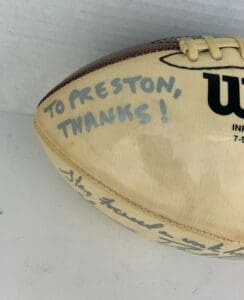 Autographed football with handwritten message.