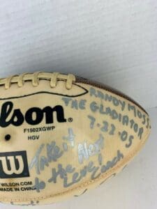 Signed football with handwritten messages and date.