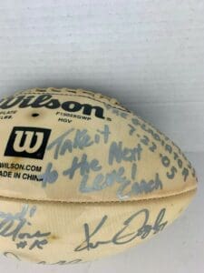 Autographed football with motivational message.